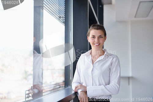 Image of Young pretty business woman with notebook in the office