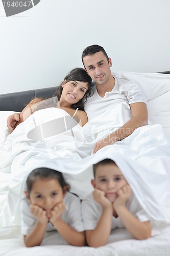 Image of happy young Family in their bedroom