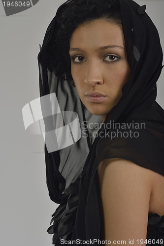 Image of elegant woman in fashionable dress posing in the studio