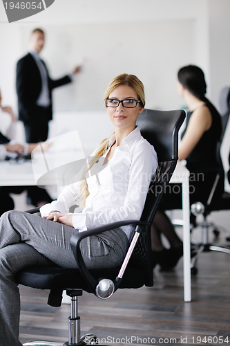 Image of business woman with her staff in background