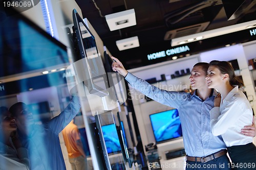 Image of Young couple in consumer electronics store