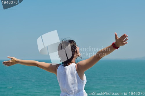 Image of happy young woman with spreading arms to sky