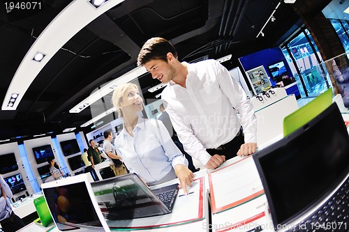 Image of Young couple in consumer electronics store