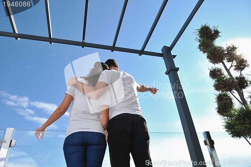 Image of couple relaxing on balcony