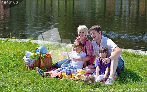 Image of Happy family playing together in a picnic outdoors