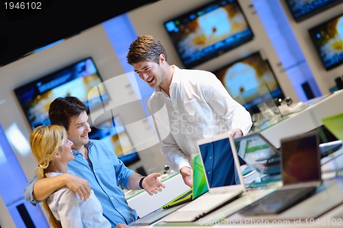 Image of Young couple in consumer electronics store