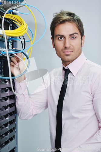 Image of young it engineer in datacenter server room