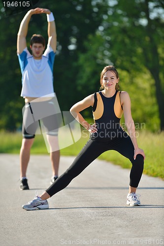 Image of Couple doing stretching exercise  after jogging