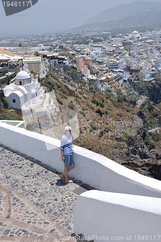 Image of Greek woman on the streets of Oia, Santorini, Greece