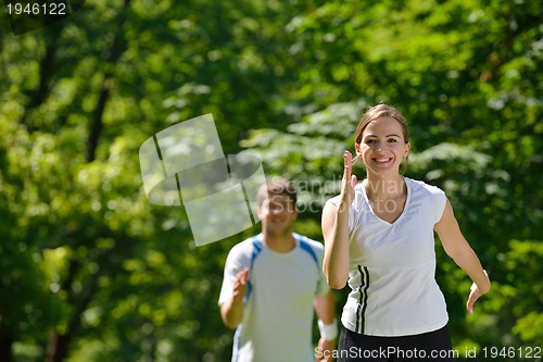 Image of Young couple jogging at morning