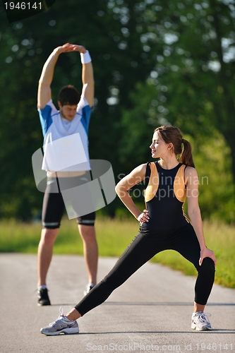 Image of Couple doing stretching exercise  after jogging