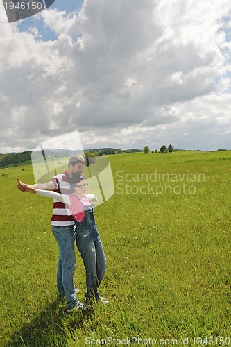 Image of Portrait of romantic young couple smiling together outdoor