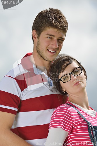 Image of Portrait of romantic young couple smiling together outdoor
