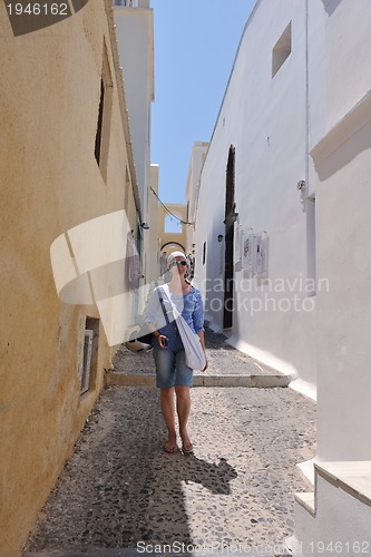 Image of Greek woman on the streets of Oia, Santorini, Greece