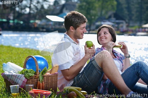 Image of happy young couple having a picnic outdoor