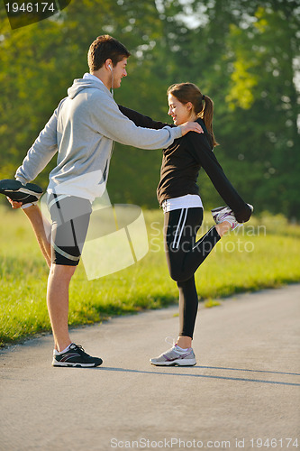 Image of Couple doing stretching exercise  after jogging