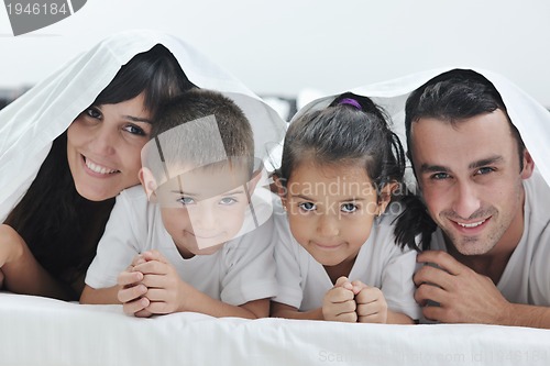 Image of happy young Family in their bedroom