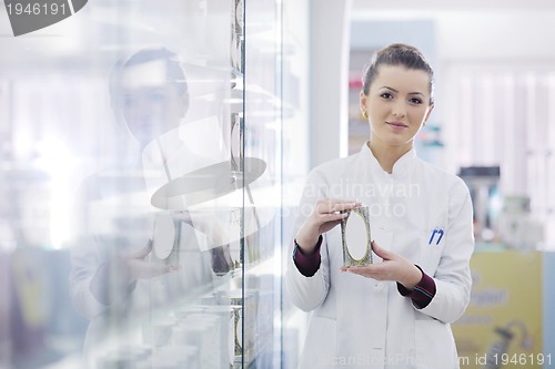 Image of pharmacist chemist woman standing in pharmacy drugstore