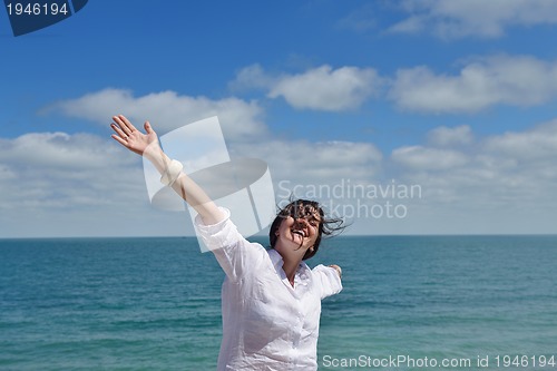 Image of happy young woman with spreading arms to sky