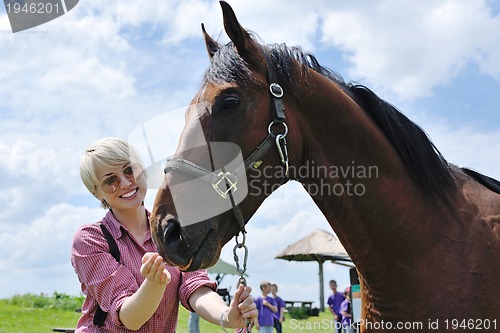 Image of happy woman  on  horse