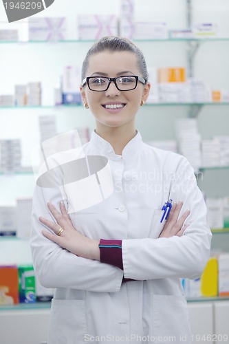 Image of pharmacist chemist woman standing in pharmacy drugstore