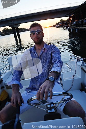 Image of portrait of happy young man on boat