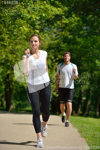 Image of Young couple jogging at morning