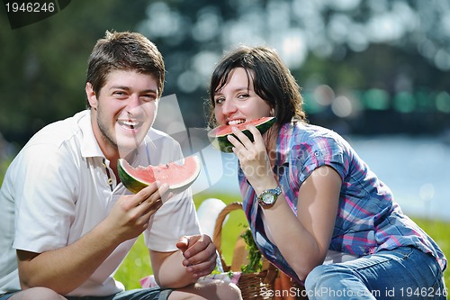 Image of happy young couple having a picnic outdoor