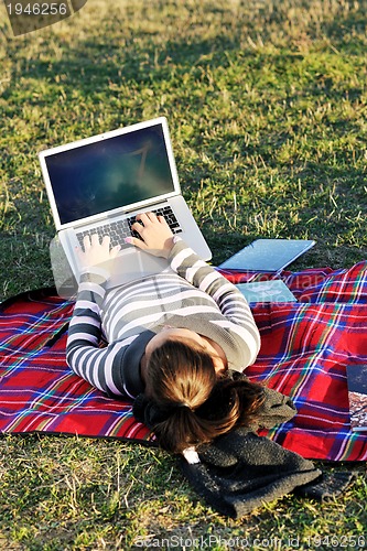 Image of young teen girl work on laptop outdoor