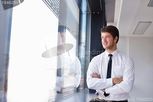 Image of business man  on a meeting in offce with colleagues in backgroun