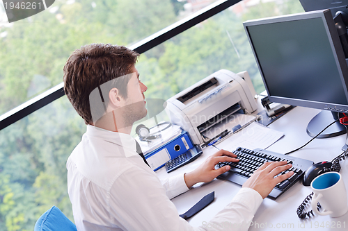 Image of happy young business man at office