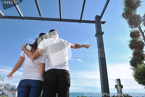 Image of couple relaxing on balcony