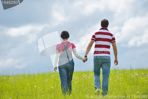 Image of Portrait of romantic young couple smiling together outdoor