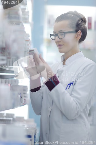 Image of pharmacist chemist woman standing in pharmacy drugstore