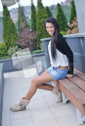 Image of beautiful young lady posing in garden