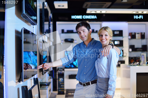 Image of Young couple in consumer electronics store