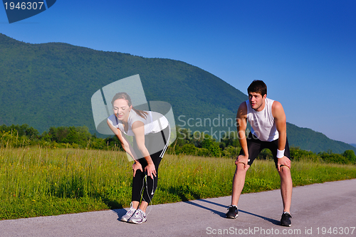 Image of Couple doing stretching exercise  after jogging