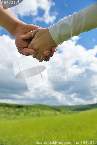 Image of Portrait of romantic young couple smiling together outdoor
