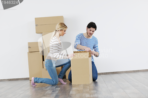 Image of Young couple moving in new house