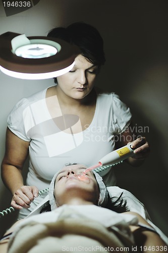 Image of woman with facial mask in cosmetic studio