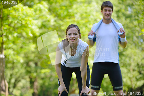 Image of Couple doing stretching exercise  after jogging