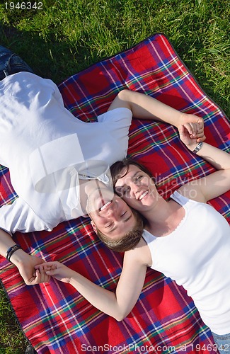 Image of happy young couple having a picnic outdoor