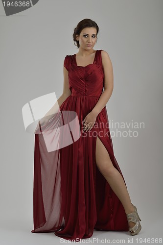 Image of elegant woman in fashionable dress posing in the studio