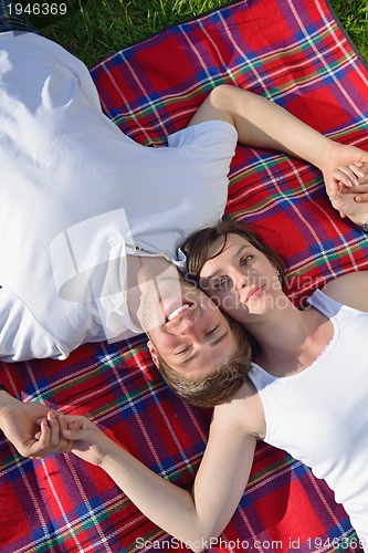 Image of happy young couple having a picnic outdoor