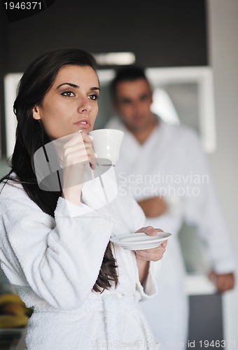 Image of Young love couple taking fresh morning cup of coffee