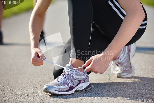 Image of Young beautiful  woman jogging at morning in park