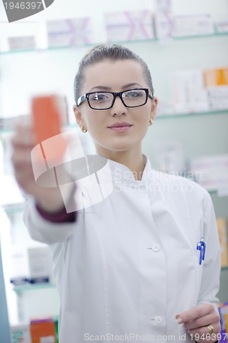 Image of pharmacist chemist woman standing in pharmacy drugstore