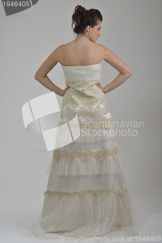 Image of elegant woman in fashionable dress posing in the studio