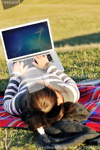 Image of young teen girl work on laptop outdoor