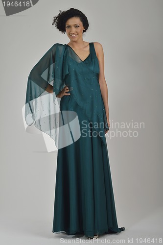 Image of elegant woman in fashionable dress posing in the studio